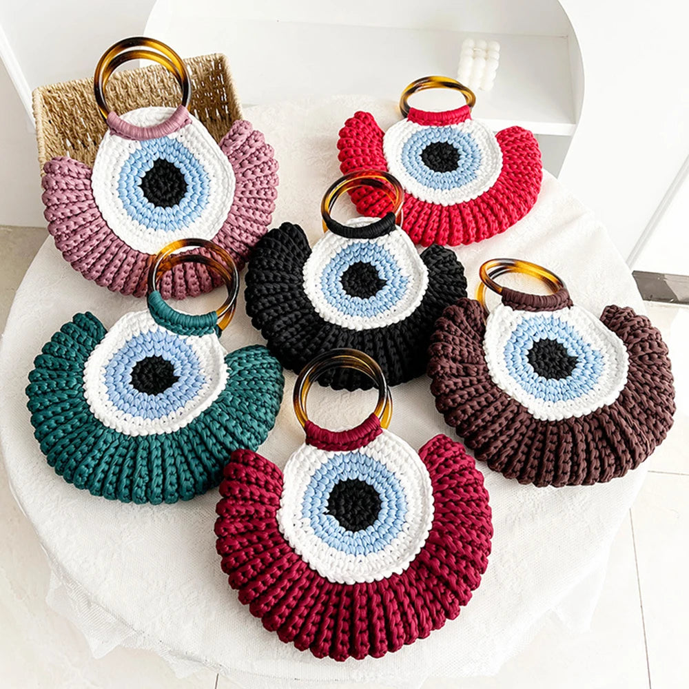 Conjunto de bolsas Olho Grego em crochê sintético, disponíveis em diversas cores vibrantes, com alças plásticas.